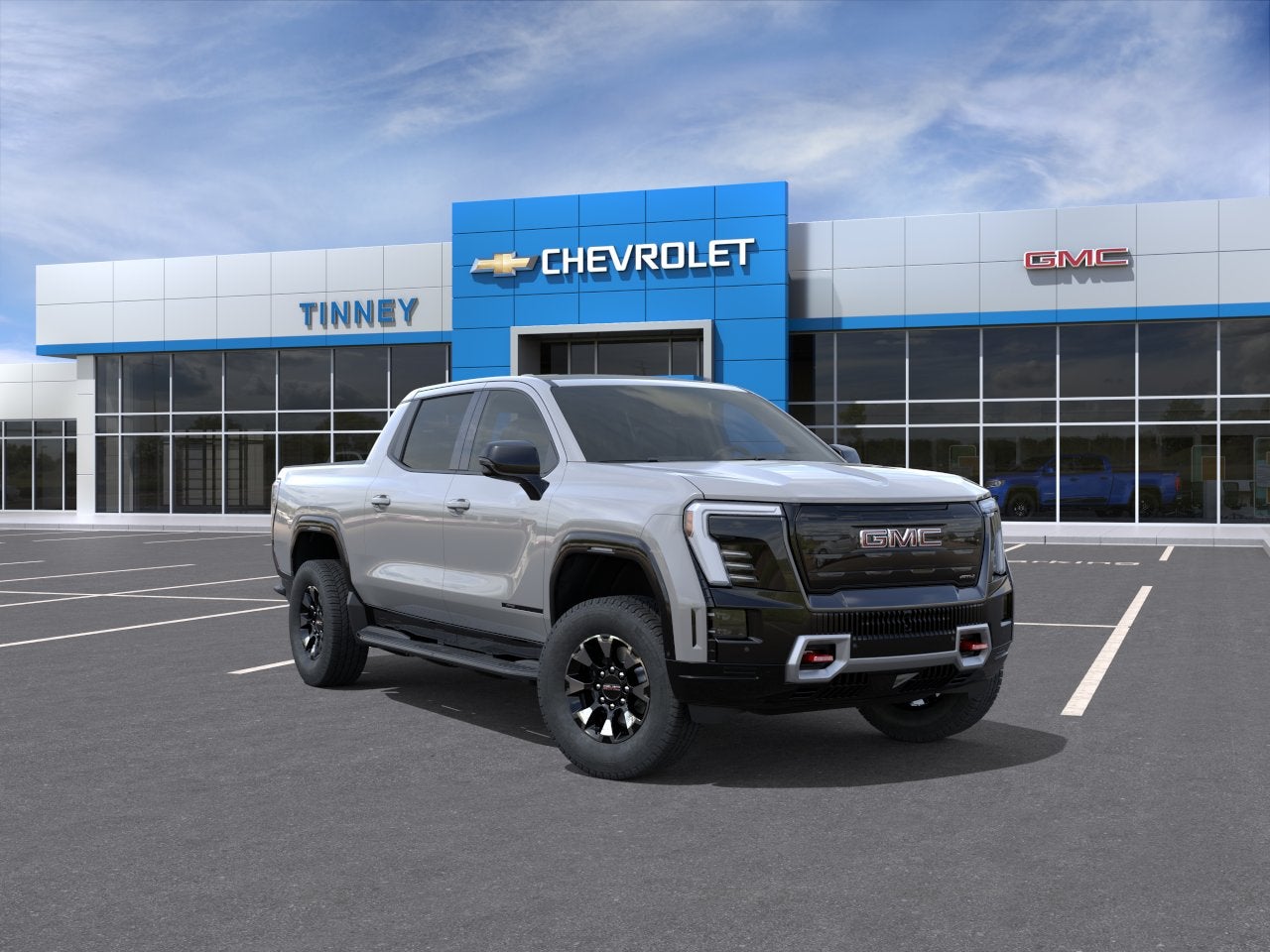 2026 GMC Sierra EV AT4 Max Range in Thunderstorm Gray — front three-quarter view