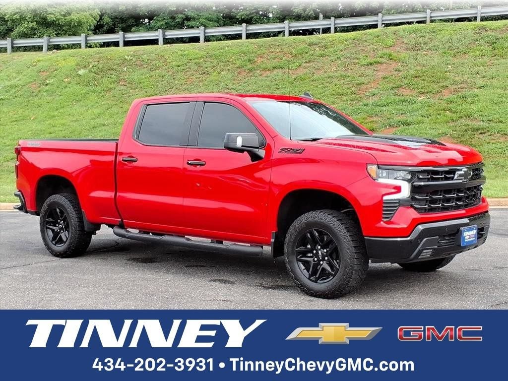 2024 Chevrolet Silverado 1500 LT Trail Boss in Red Hot — front three-quarter view